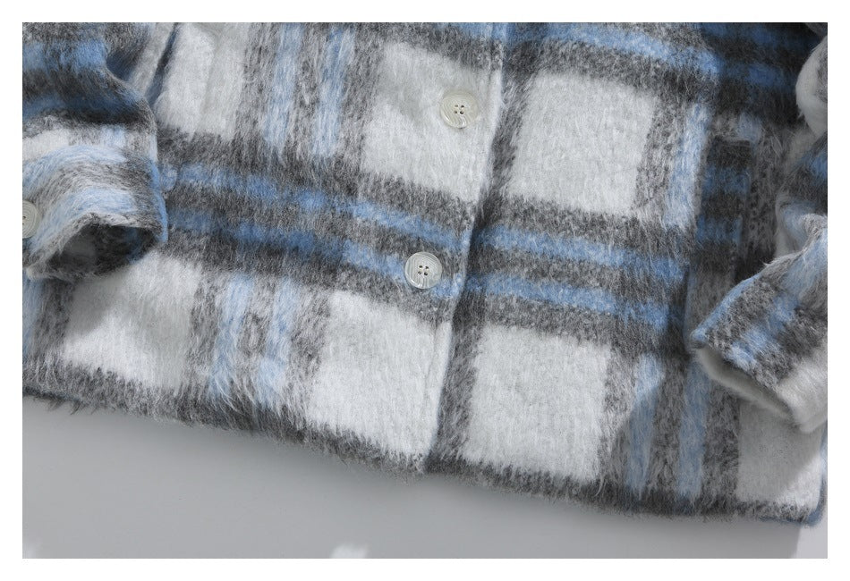 Close-up of the jacket's fuzzy blue, gray, and white plaid fabric, front buttons, and lower hem.