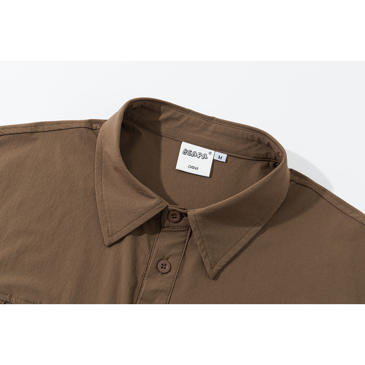 Close-up of a brown shirt collar, button placket, and sewn-in size label.