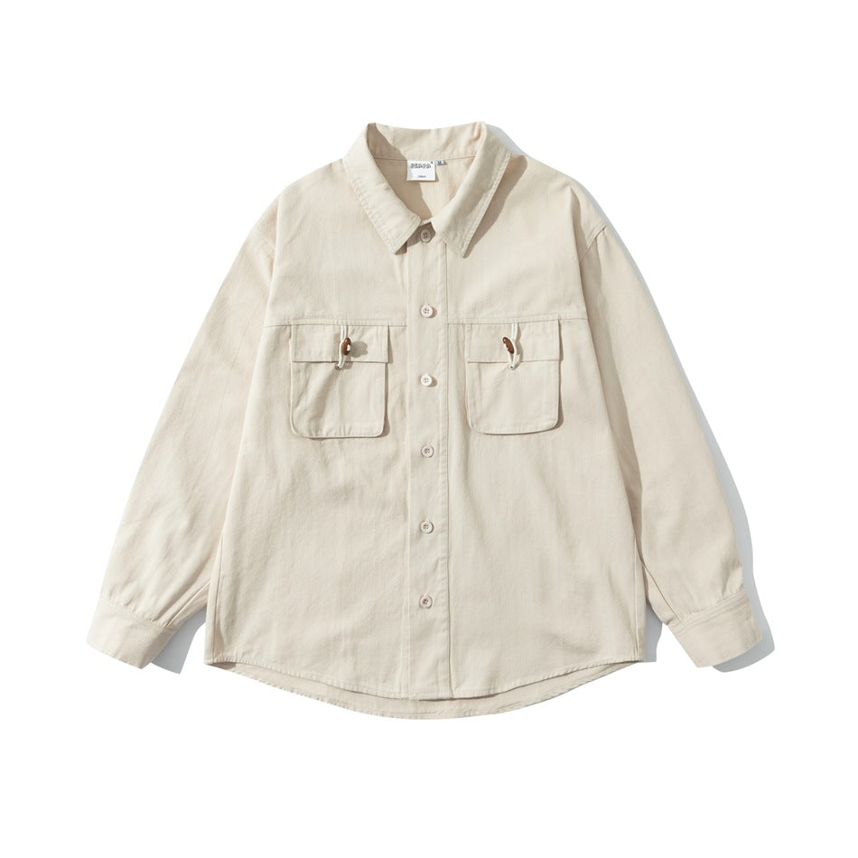 Beige long-sleeve button-up shirt with two flap chest pockets and wooden bead toggles, flat lay front view