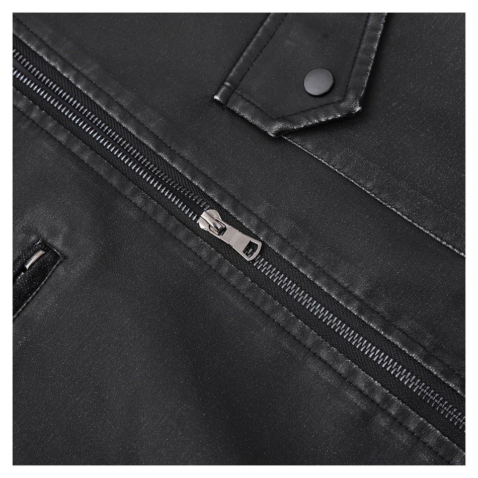 Close-up of the black jacket's diagonal zipper and a snap-button tab.