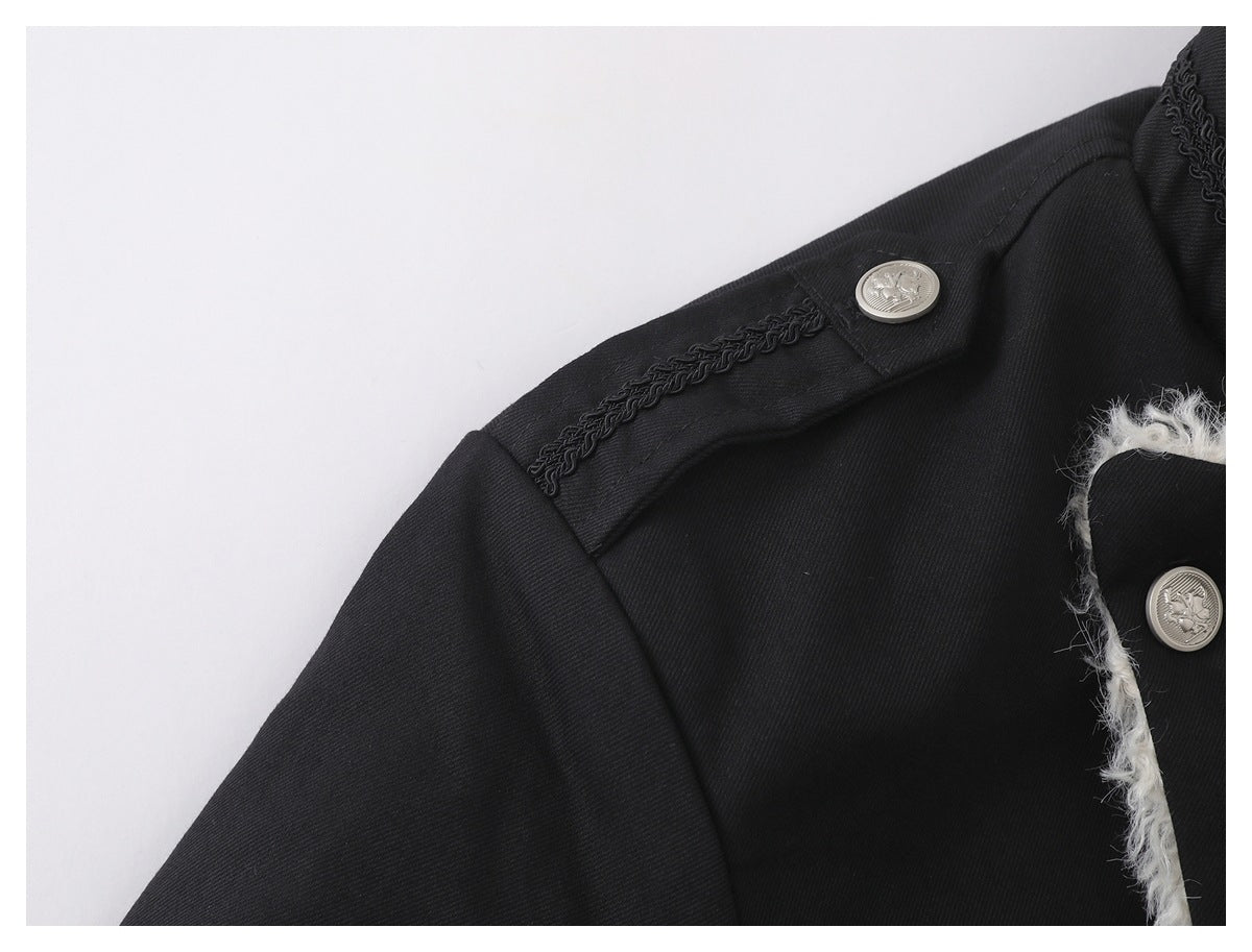 Close-up of a black jacket shoulder with braided trim and a silver button; white lining shows at the front edge.
