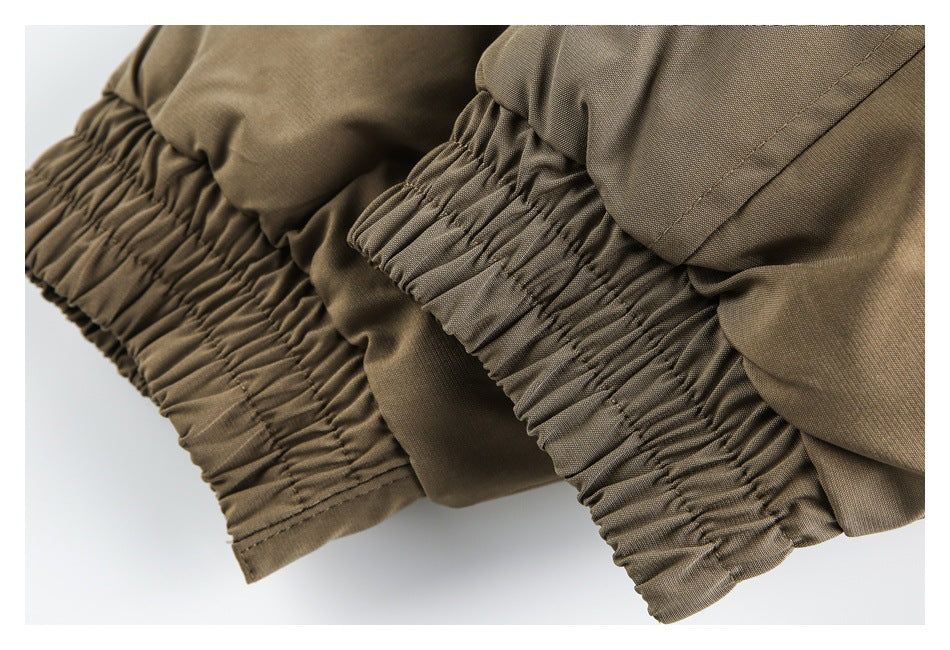 Close-up of gathered elastic edges on a taupe garment.