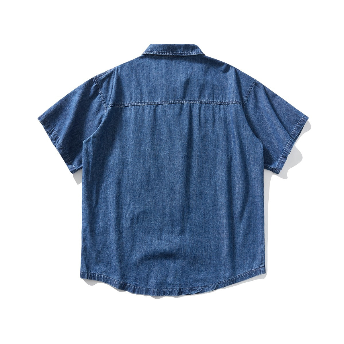 Back view of a blue denim short-sleeve button-up shirt laid flat against a white background.