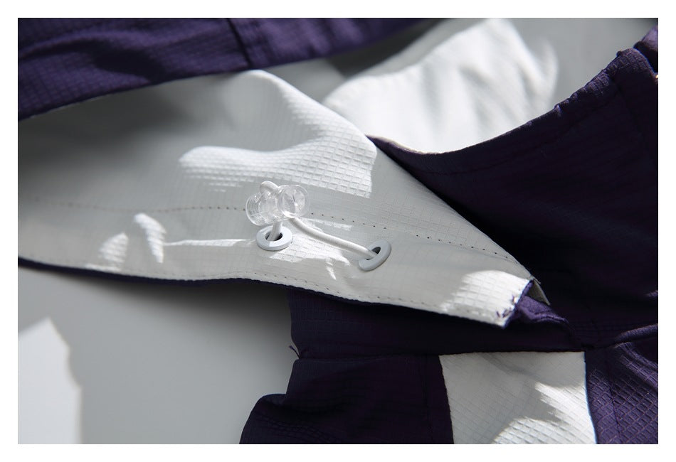 Close-up of a white hood drawcord and toggles on the purple jacket.