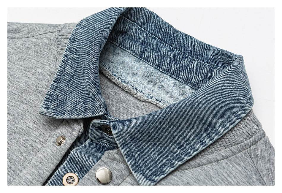 Close-up of the jacket's blue denim collar, gray body, and metal snap fasteners.