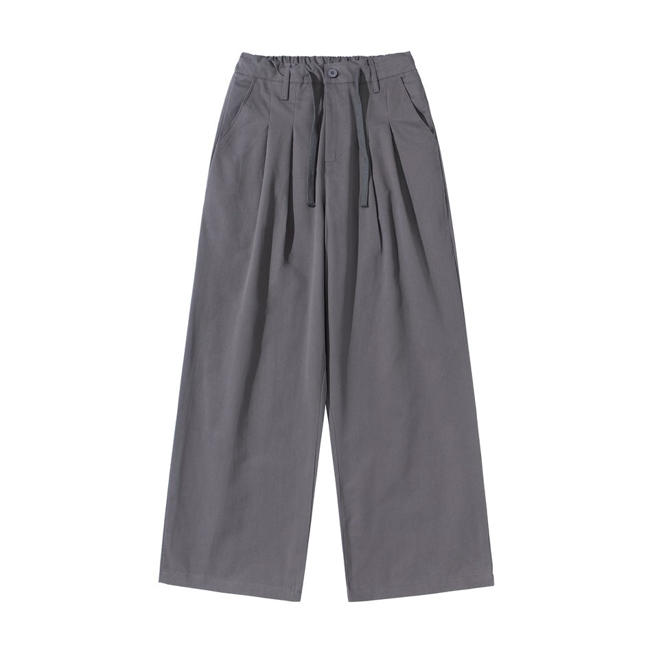 Gray wide-leg pleated pants with elastic waistband, drawstring, button closure and slant pockets, flat lay front view