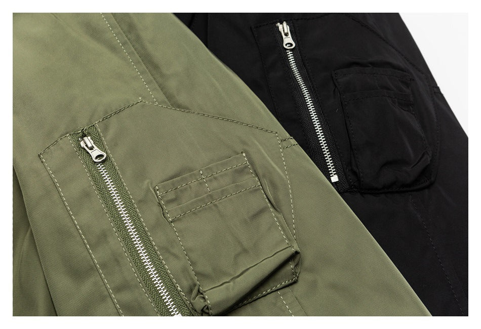 Close-up of olive and black parka pockets, showing zippered and flap pocket details.