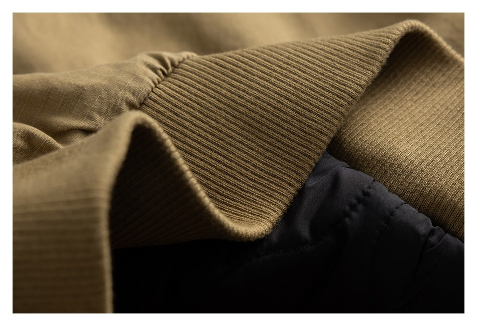Close-up of khaki ribbed trim beside black padded fabric.