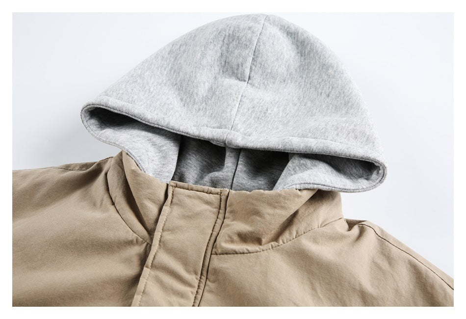 Close-up of a tan jacket with a light gray hood, showing the hood opening and raised collar.