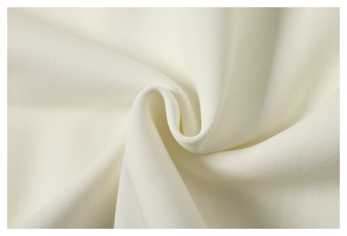 Close-up showing the soft folds and fine surface texture of ivory fabric.