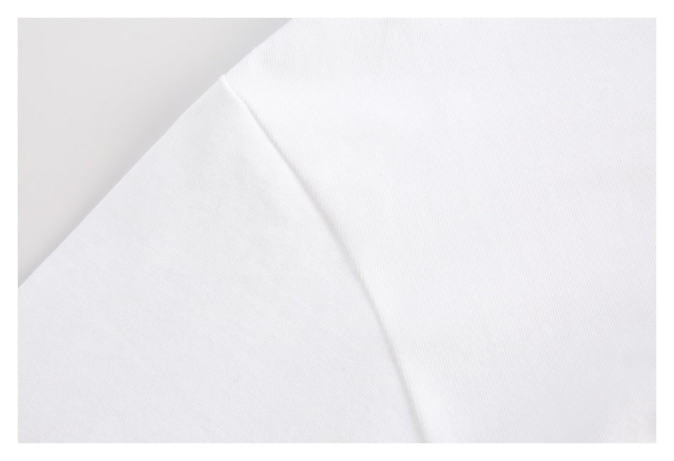 Close-up of plain white fabric folded diagonally, showing its fine surface texture.