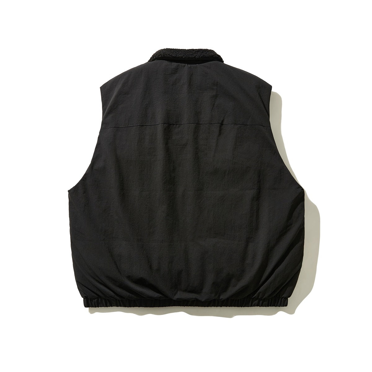 Back view of a black sleeveless vest with a fleece collar and elastic hem.