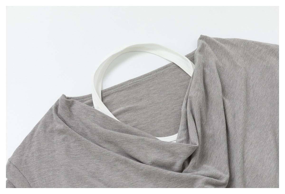 Close-up of the gray top's draped neckline, with a white hanger visible behind it.