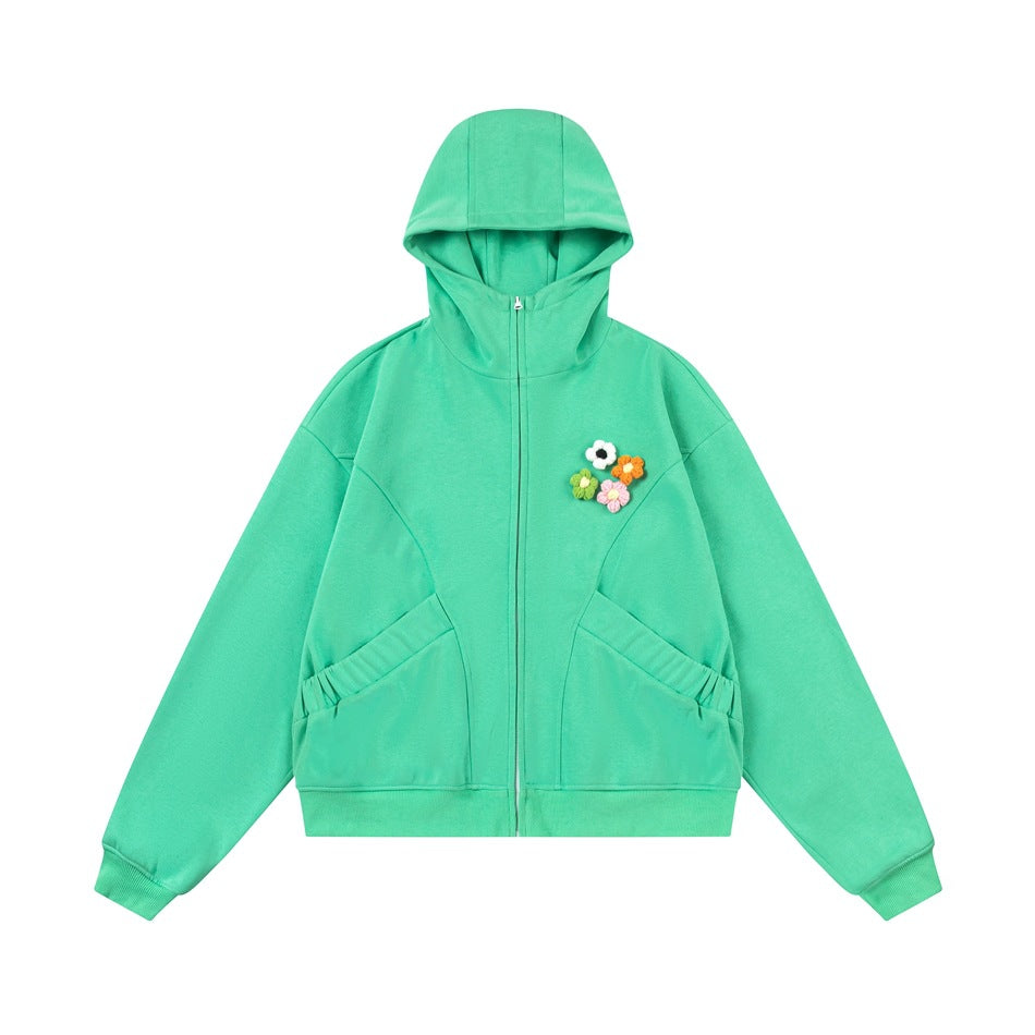 Green zip-up hoodie flat lay with four small flower appliques on the chest and ribbed cuffs and hem