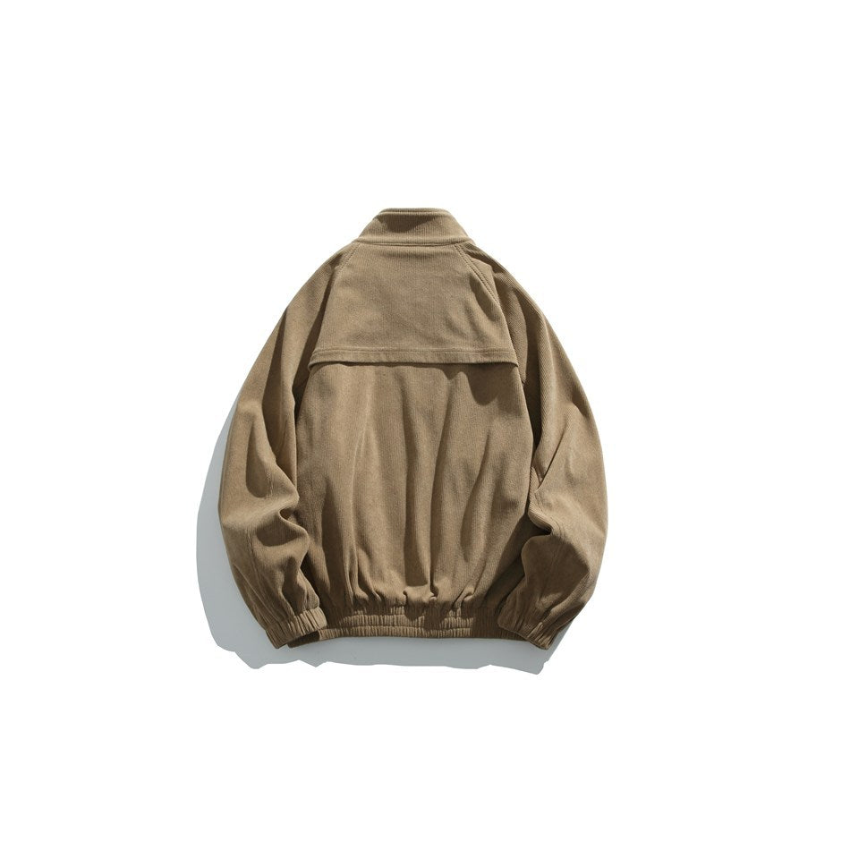 Back view of a tan jacket with a raised collar, shoulder yoke, and elasticated cuffs and hem.