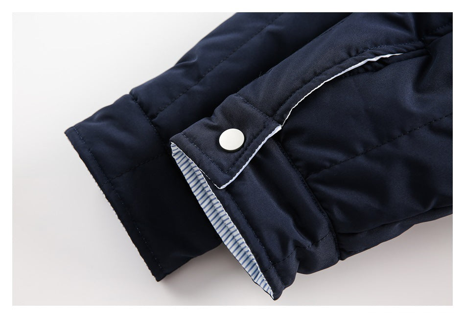 Close-up of a navy cuff with a snap tab and blue-striped lining.