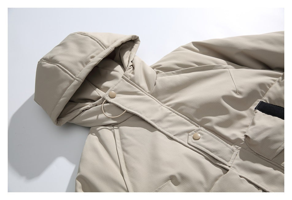 Close view of the beige jacket's hood, snap-button front placket, and upper panels.