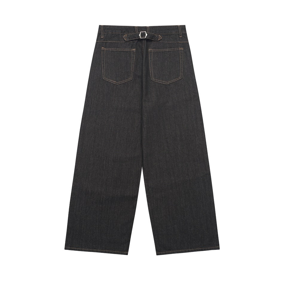 Back view of black wide-leg jeans with two patch pockets, a buckle detail at the waistband, and contrast stitching.
