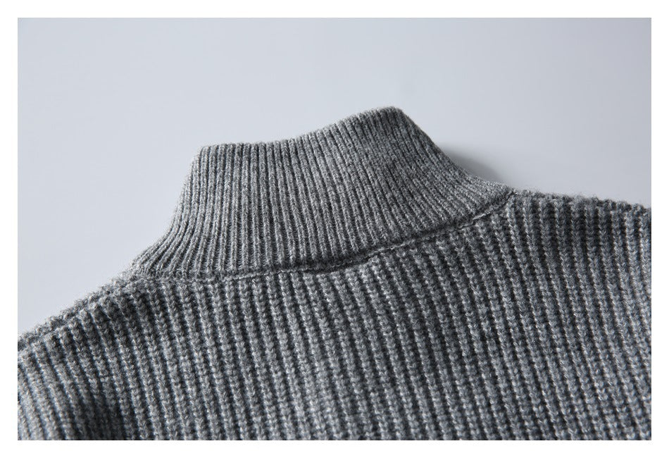 Close-up of a gray rib-knit sweater with a tall, folded neckline.