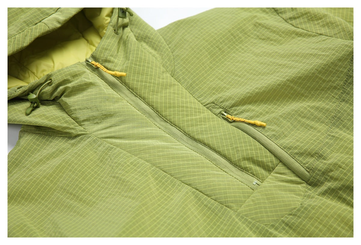 Close-up of the lime green grid-pattern jacket front, showing two zippers with yellow pulls.