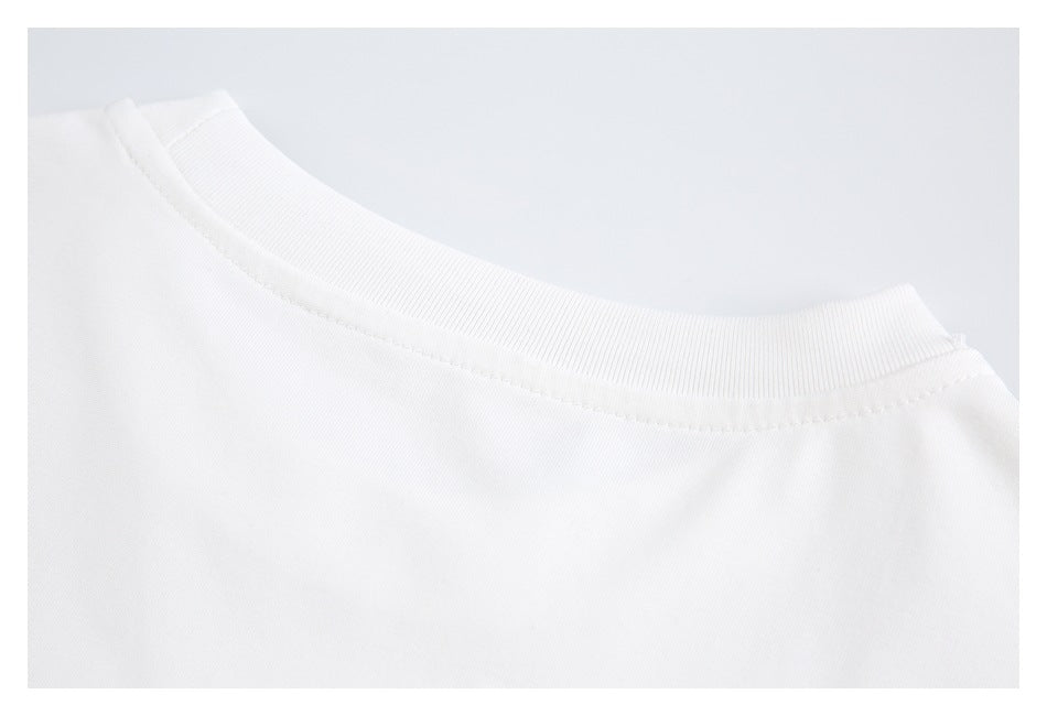 Close-up of a white crew-neck garment showing its ribbed collar and neckline stitching.