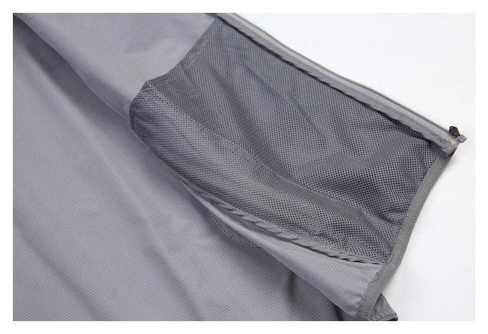 Close-up of gray striped garment opened to show dark mesh lining and a zipper.