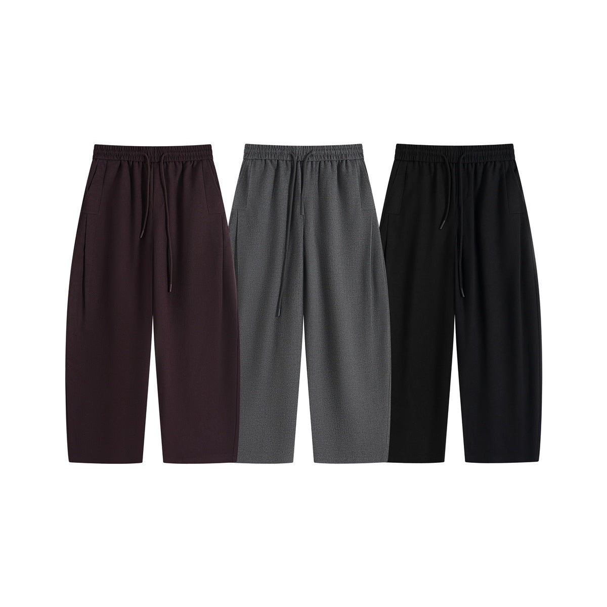 Three pairs of wide-leg drawstring pants shown from the front in burgundy, charcoal gray, and black.
