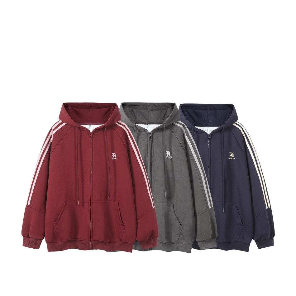 Three front views of zip-up hoodies in burgundy, gray and navy, each with a hood, pale sleeve stripes and pockets.
