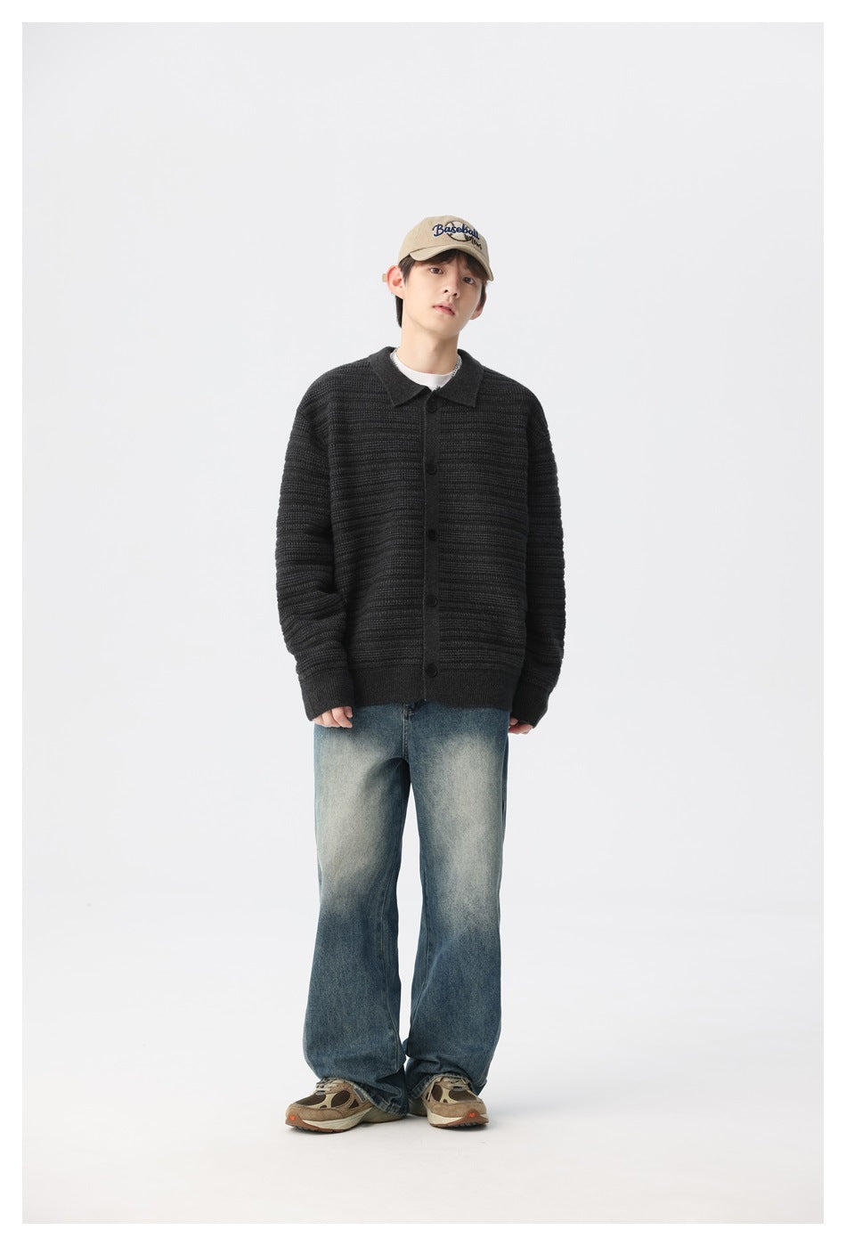 Full-length model wearing a black ribbed button-front cardigan with a collar, blue jeans, and sneakers.