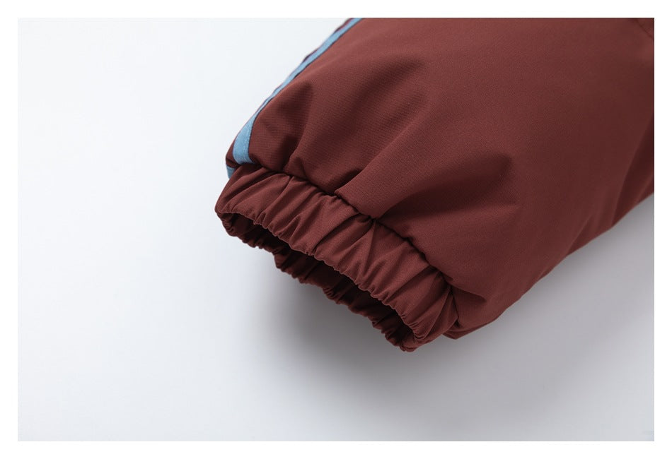 Close-up of the jacket's burgundy sleeve ending in a gathered elastic cuff, with a blue stripe along the sleeve.