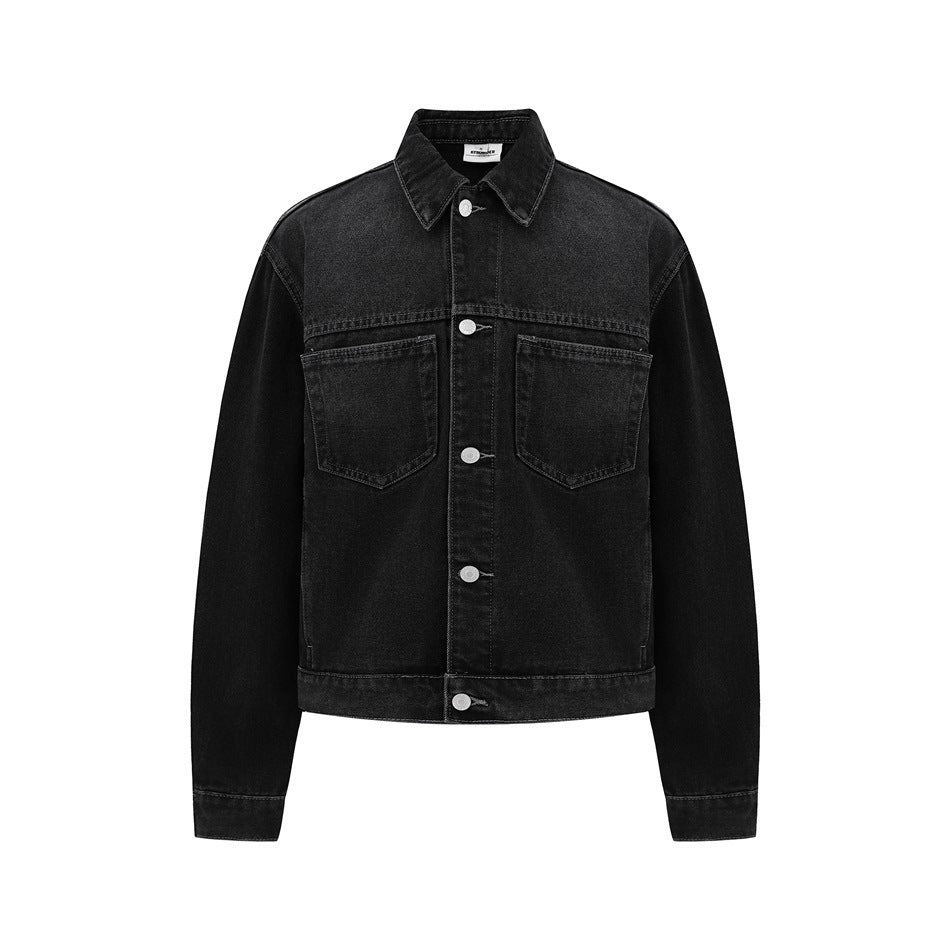 Black washed denim trucker jacket front view with button closure and two chest pockets on a white background