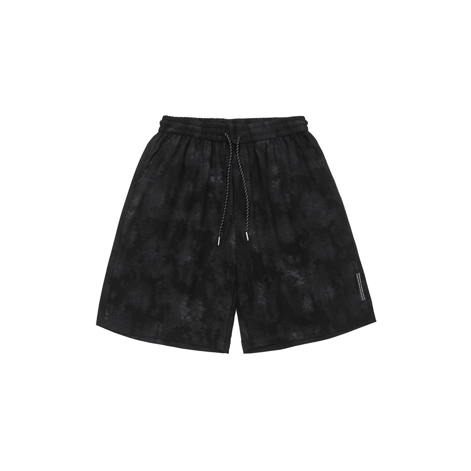Black mottled-wash drawstring shorts with elastic waist, front view on a white background