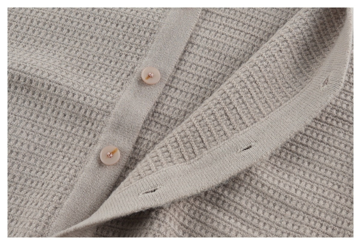 Close-up of the taupe cardigan's textured knit, button front, and buttonhole placket.