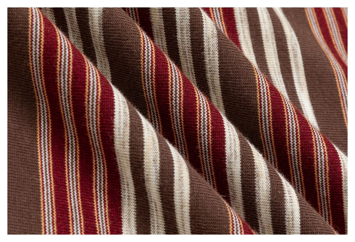 Extreme close-up showing the knit texture and brown, burgundy, and cream stripes of the garment.