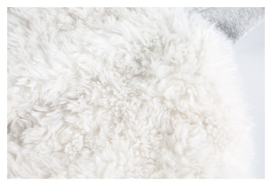Close-up of the garment's dense white shaggy faux-fur surface.