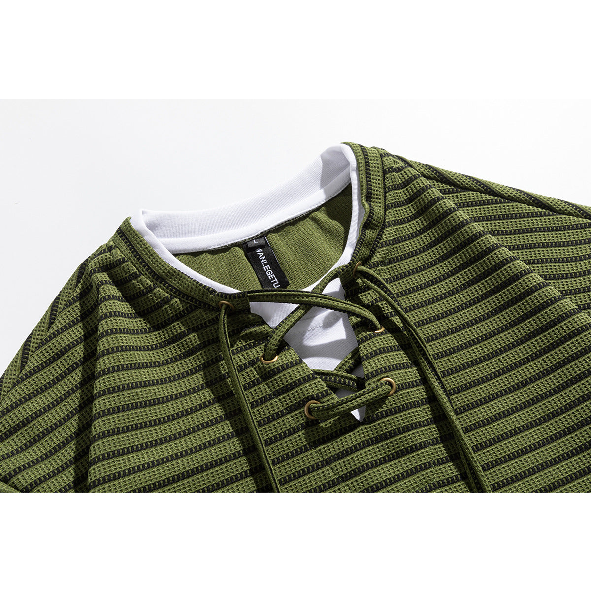 Close-up of an olive-green and black striped top with a white inner collar and lace-up neckline.