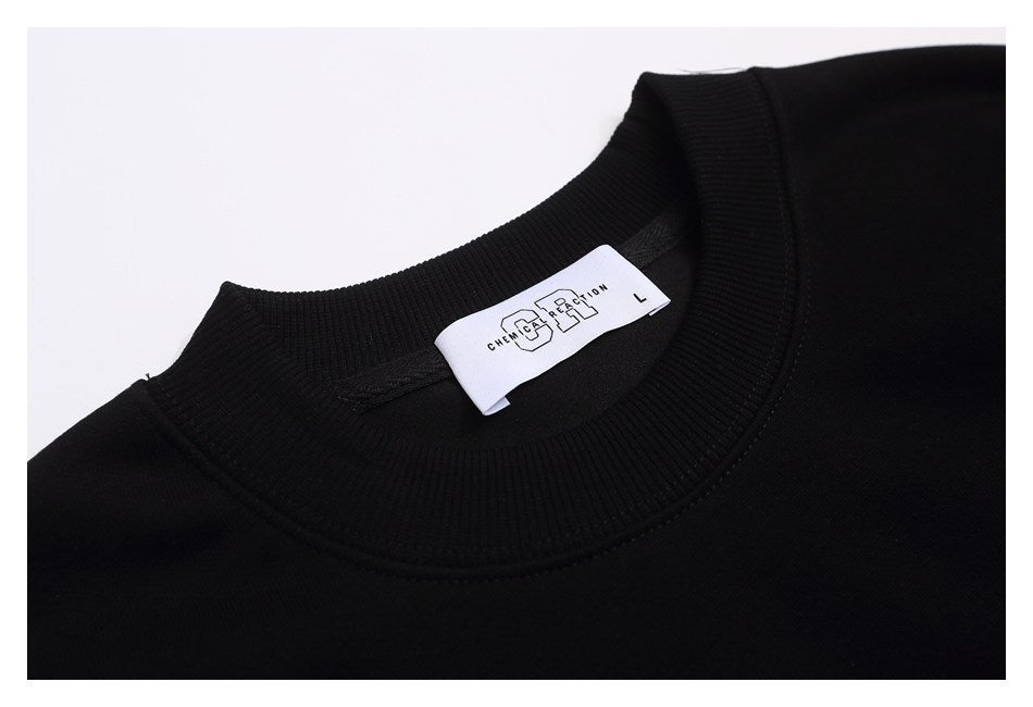 Close-up of the black sweatshirt's ribbed crew neck and white size L label.