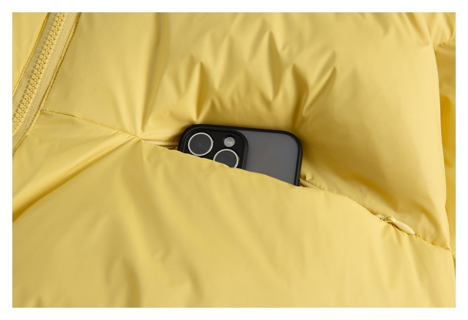 Close-up of a yellow jacket pocket holding a smartphone, with the zipper visible along the left edge.