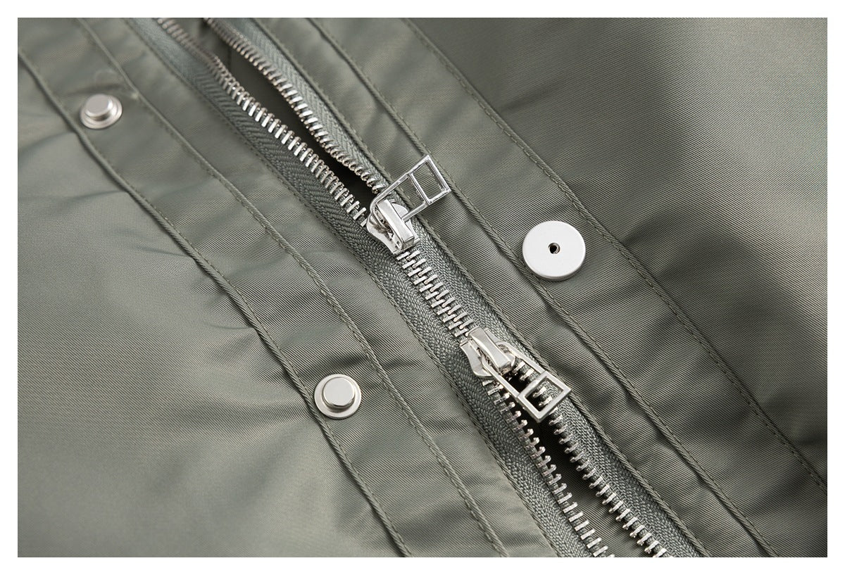 Close-up of the jacket’s silver front zipper and snap-fastened placket.