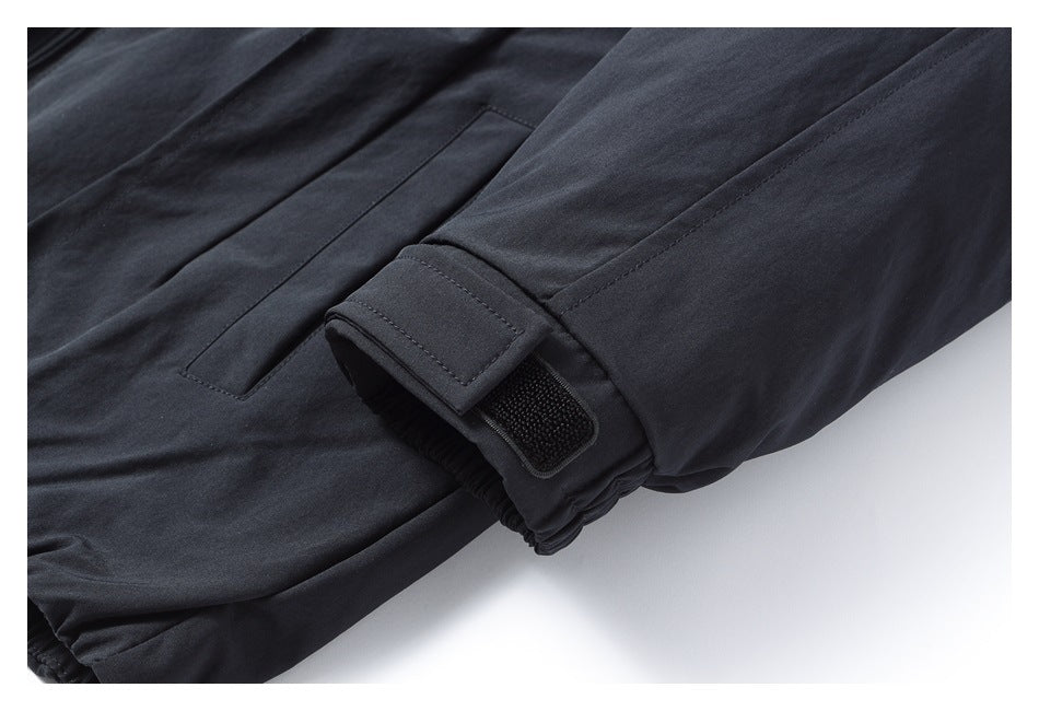 Close-up of a dark trouser cuff with an adjustable hook-and-loop tab.