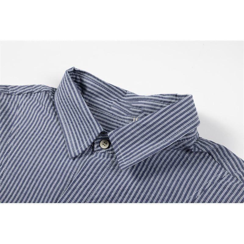 Close-up of a blue-gray striped short-sleeve shirt collar and top button.