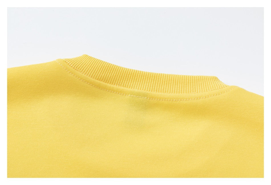 Close-up of the yellow sweatshirt's ribbed neckline and surrounding shoulder fabric.