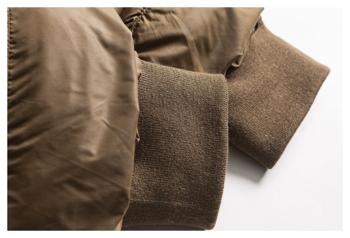 Close-up of the brown jacket's sleeve and wide rib-knit cuff.