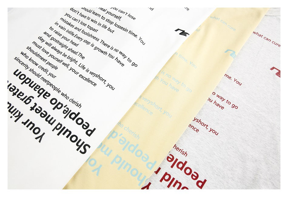 Three T-shirts in white, pale yellow, and light gray show English text prints in black, blue, and red.