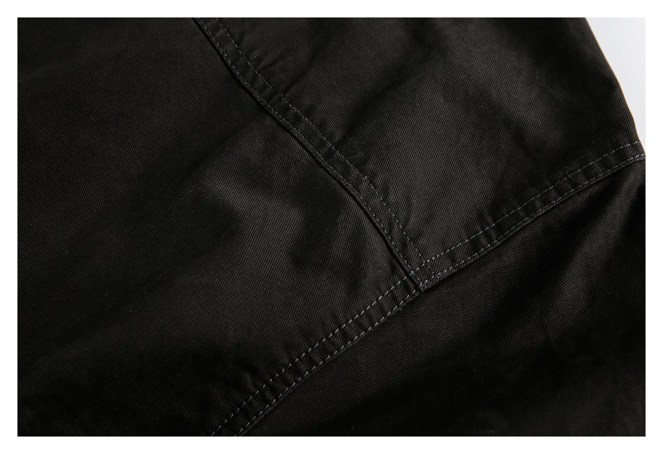 Close-up of black fabric with intersecting rows of dark stitching.
