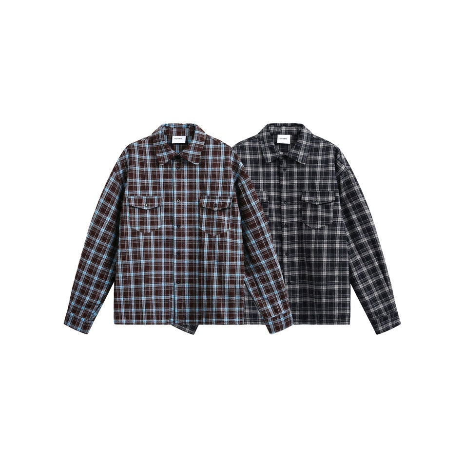 Two plaid button-up shirts with pointed collars and flap chest pockets, shown in brown-blue and charcoal-gray colorways.