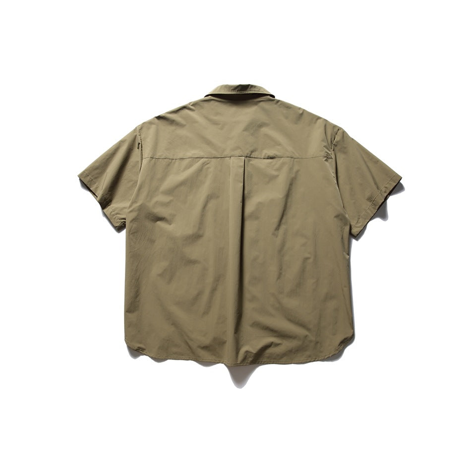 Back view of an olive-brown short-sleeve button-up shirt laid flat, showing a center pleat.