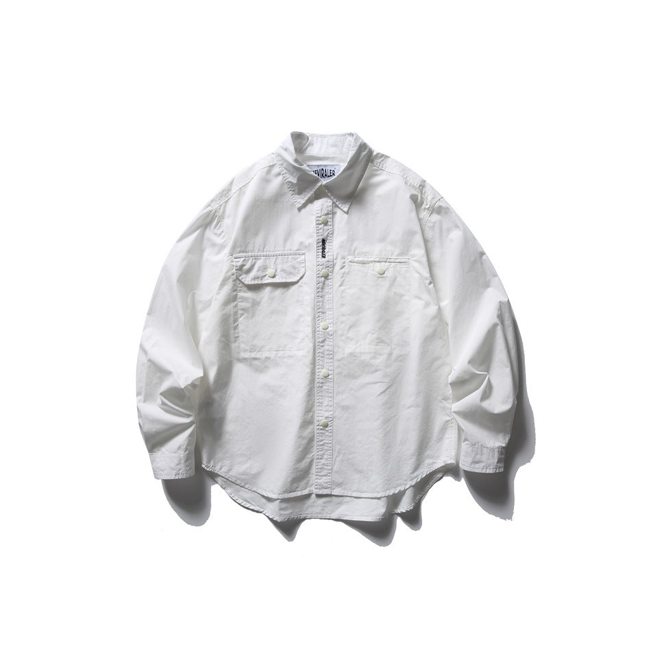 White long-sleeve button-front shirt with pointed collar, two chest pockets with snaps and curved hem, flat lay