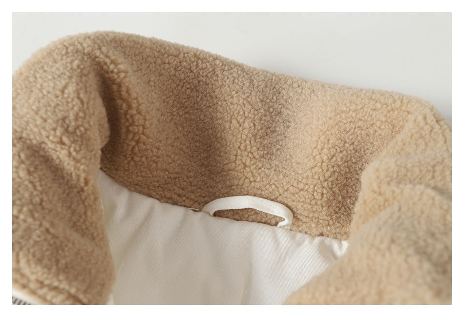 Close-up of the tan fleece lining inside the collar of a white jacket, with a small hanging loop.