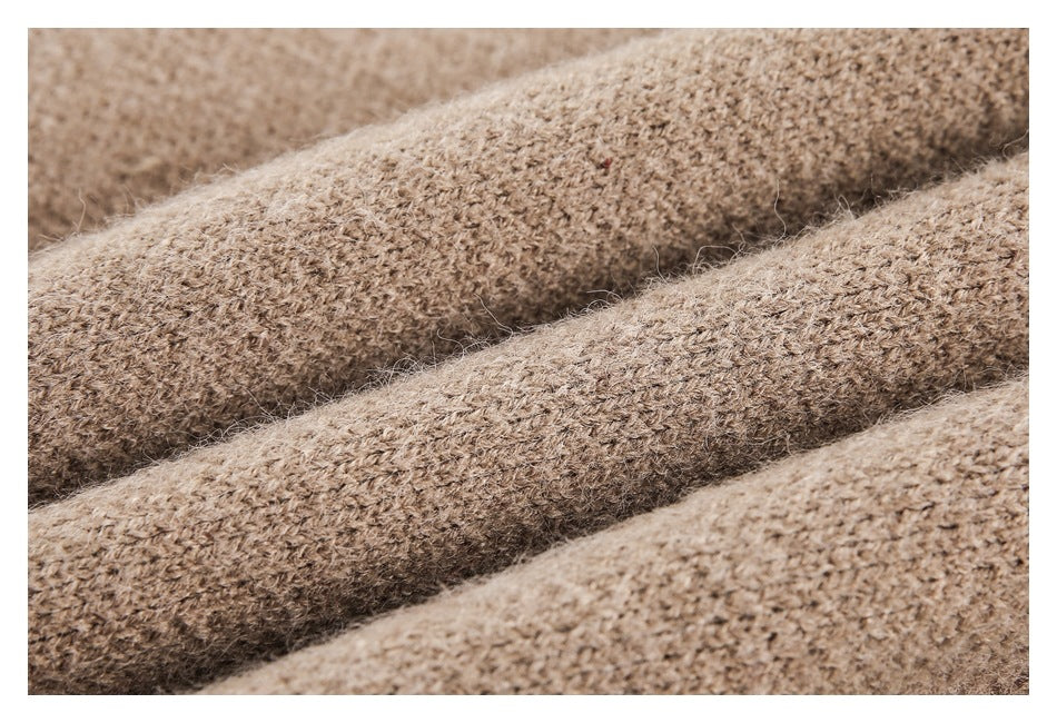 Macro view of the fuzzy, looped knit texture of taupe-brown fabric.